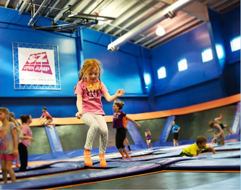 a group of kids jumping on a trampoline