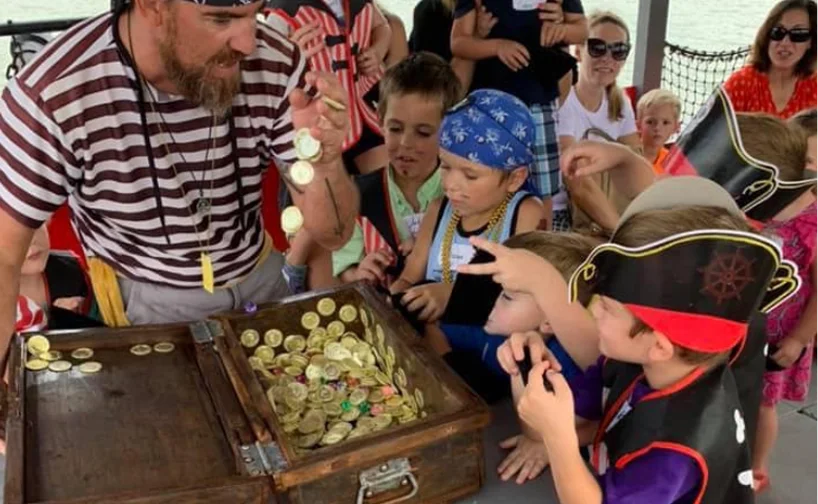 a group of kids looking at a treasure chest